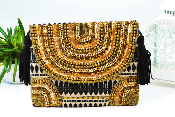 Bohemian Hand embellished Sling/ Clutch Bags – Gold and bronze embellished with black tassels.